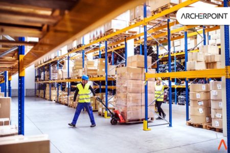 warehouse with worker pulling pallet of boxes