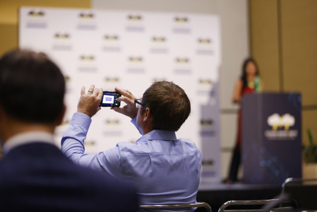 Attendees capture slides containing key insights from Google Cloud's Industry Cloud Battleground presentation on financial services